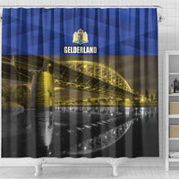 Blue shower curtain with GELDERLAND crest and illuminated bridge and water photo