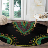 Black round carpet with green center medallion and yellow botanical dashiki border