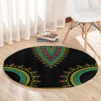 Black round carpet with green-and-yellow dashiki medallion and curved border