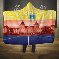 Hooded blanket with yellow zigzag hood and Netherlands flag design over a blue drape