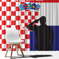 Close-up view of red-and-white checkered curtain with Croatia crest and black silhouette