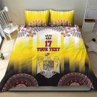 Yellow and black bedding set with eagle crest on striped duvet and round ornamental hem