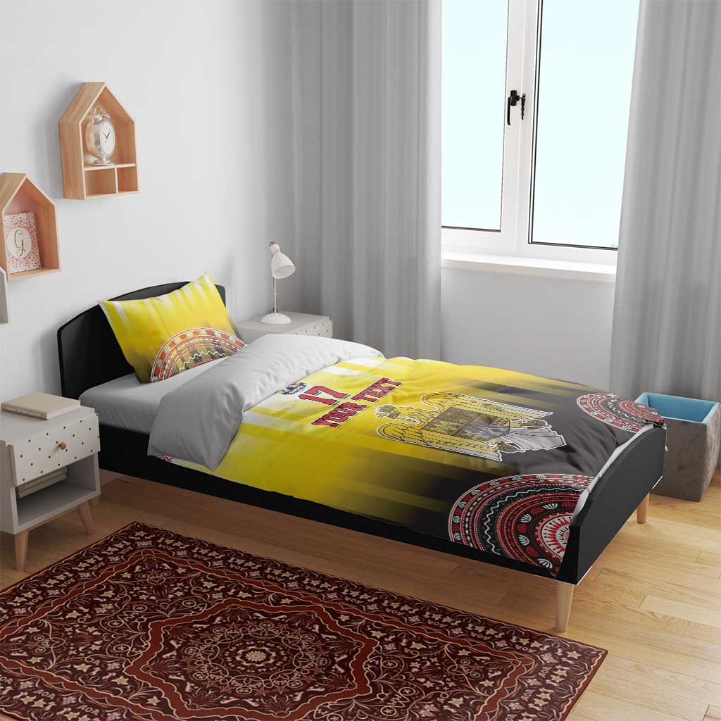 Yellow and black striped bedding set with eagle crest on duvet and patterned circular hem