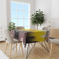 Yellow tablecloth over dining table with colorful tribal-style border pattern