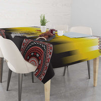 Yellow and black tablecloth with red circular stripe motif and patterned edge