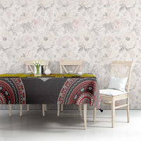 Yellow and black tablecloth with red circular motif across dining table