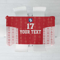 Red and white football tablecloth with repeating Tupilaq-style pattern and center number block