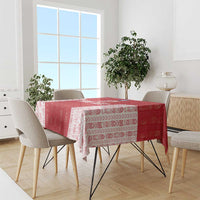 Red and white patterned football tablecloth draped over dining table