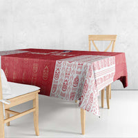 Red and white football tablecloth with patterned border over bench and table