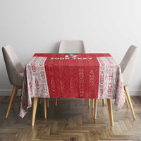 Red and white football tablecloth over dining table with four chairs