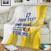 Football blanket draped on armchair, white with yellow stripes and number 17 text print