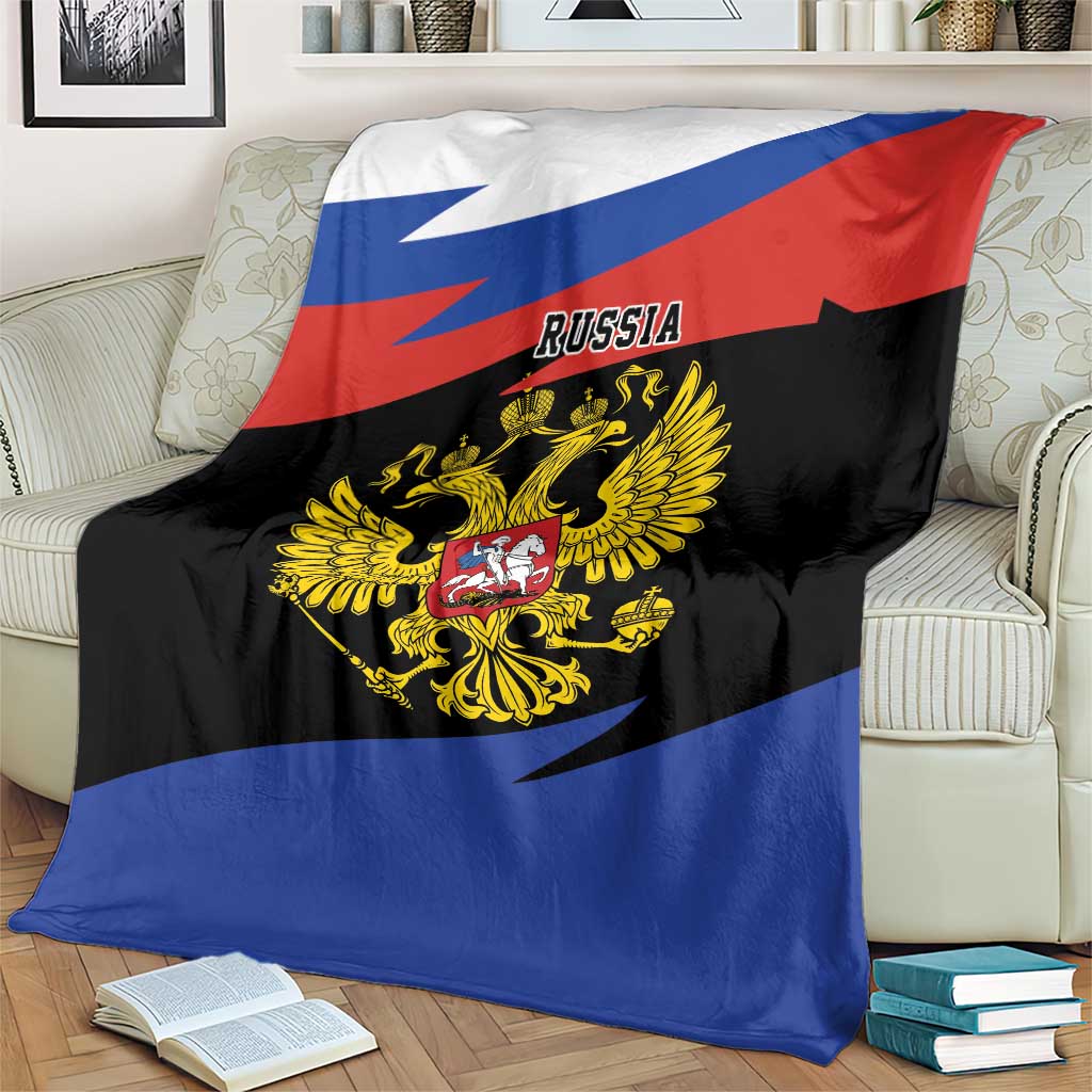 Russia eagle blanket on couch, black center with gold crest, red top and blue bottom