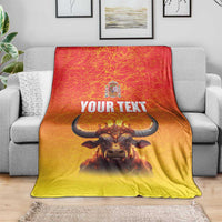 Personalized Spain blanket with crowned bull, coat of arms, and 'YOUR TEXT' on sofa