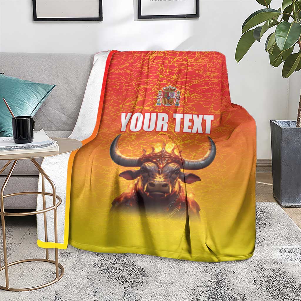Personalized Spain blanket with crowned bull and 'YOUR TEXT' on gray couch