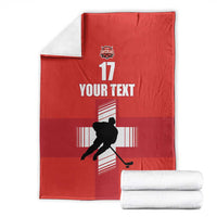 Folded red ice hockey blanket with hockey player silhouette, YOUR TEXT, and 17 graphic