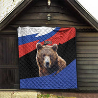 Quilt blanket with Russian flag design and brown bear artwork, hanging outdoors