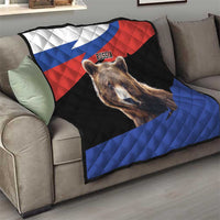 Quilt blanket with brown bear portrait and Russian flag colors, laid on a sofa