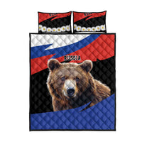Quilt bed set with central brown bear face, black red and blue quilt design, two pillows