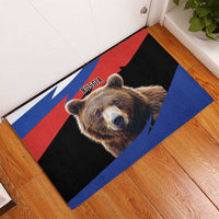 Brown rubber doormat featuring Russia flag stripes and bear face, angled on floor
