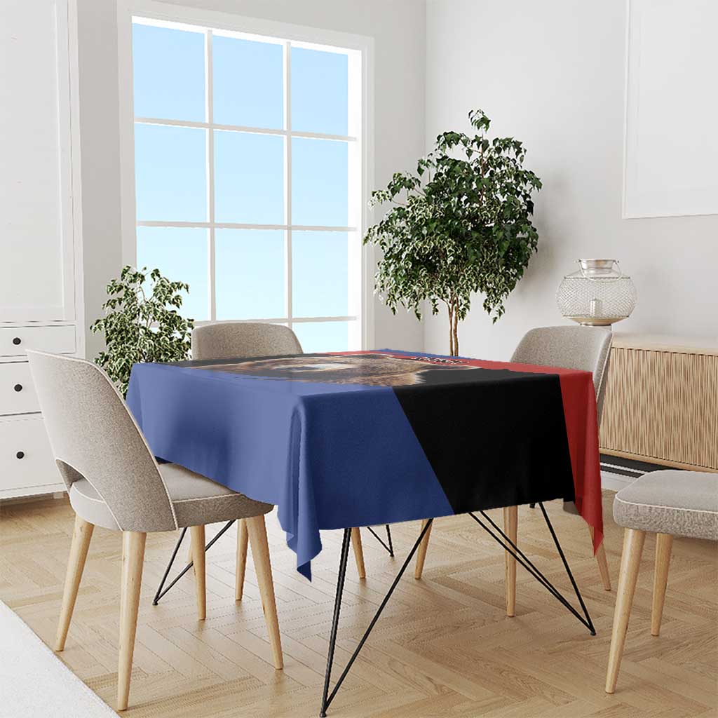 Bear graphic tablecloth draped over dining table with blue, red, and black design center