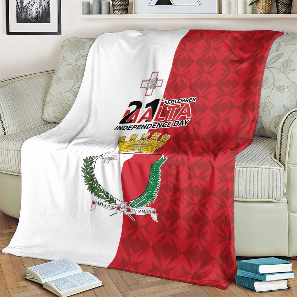 Flag-style Malta Independence Day blanket on a sofa, showing red shield coat of arms