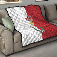 Malta Independence Day quilt blanket on sofa, white-and-red diamond pattern with emblem