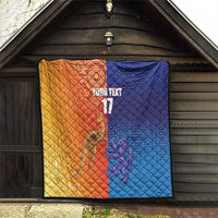 Orange and blue diamond-quilt blanket hung on wall with centered 'YOUR TEXT' and '17'