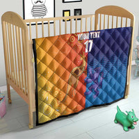 Orange and blue diamond-quilt blanket in a baby crib with centered 'YOUR TEXT' and '17'