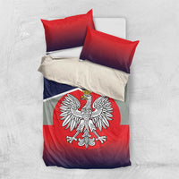 Bedding set with red and navy flag-print duvet and crowned eagle emblem; two red pillows