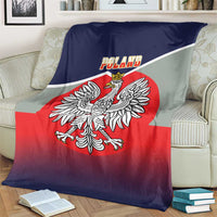 Poland-themed blanket on a couch, crowned eagle crest with red center and dark blue edge