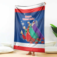 Blue Three Kings Day blanket hanging with red-and-white stripes and illustrated kings