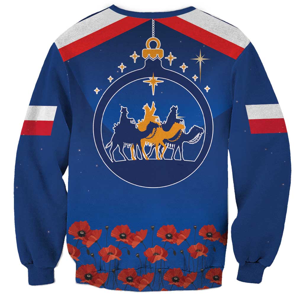 Blue sweatshirt with circular Three Kings graphic and red flower row