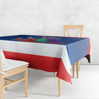Blue and red Three Kings Day tablecloth draped over square dining table