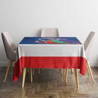 Blue and red Three Kings Day tablecloth with nativity artwork on tabletop