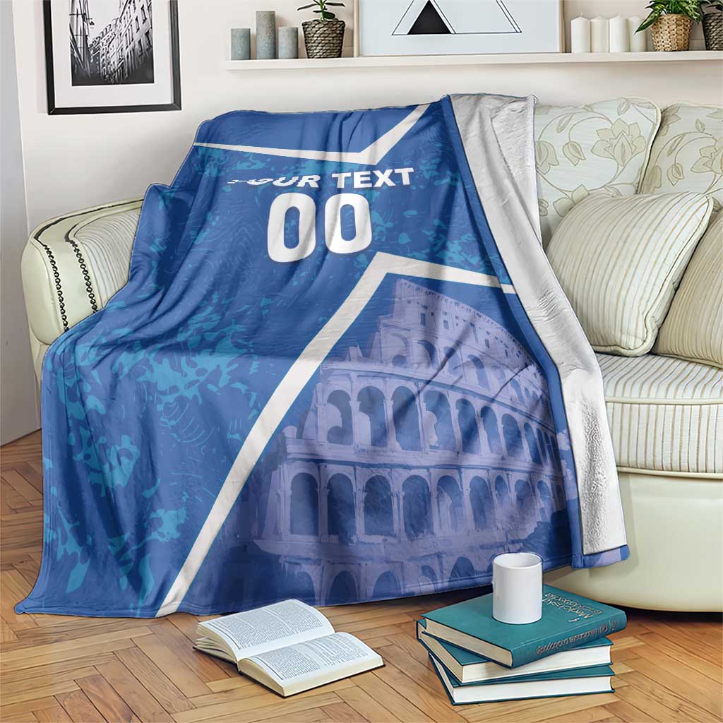 Blue football blanket draped on a sofa with white stripes, “YOUR TEXT 00,” and Colosseum image