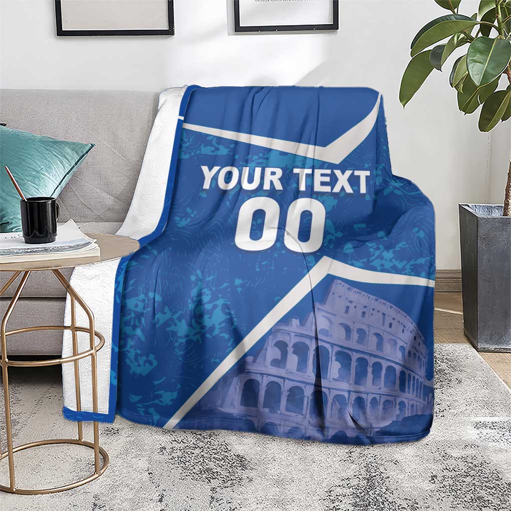 Blue throw blanket with white diagonal accents, “YOUR TEXT 00,” and Colosseum artwork