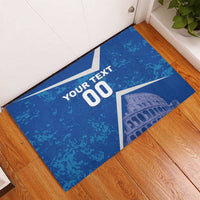Blue rectangular rubber doormat, white custom text and Colosseum graphic corner view