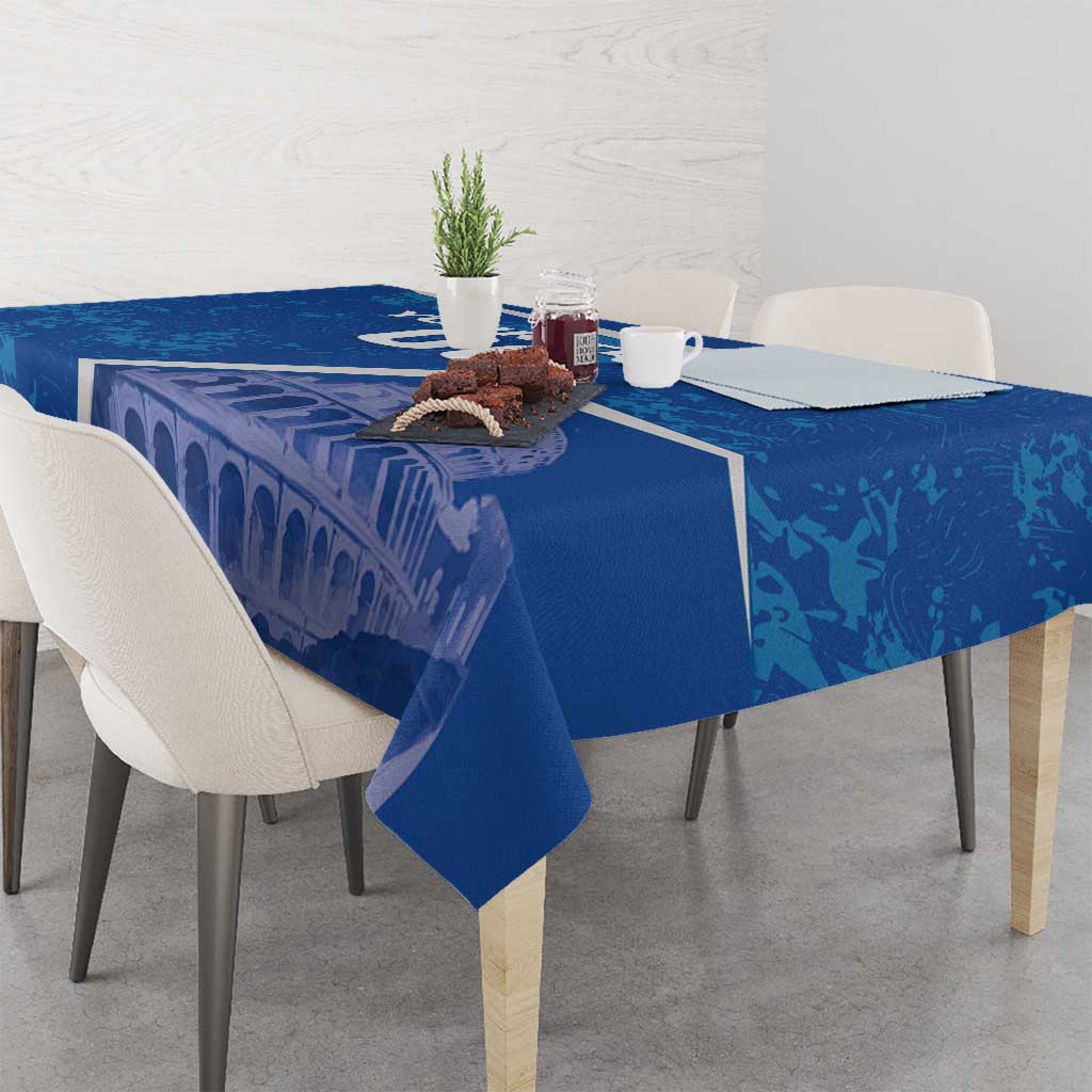 Blue tablecloth with Colosseum graphic and white border, draped over dining table