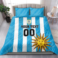 Blue bedding set with white vertical stripes, sun artwork, crest, and "YOUR TEXT 00".