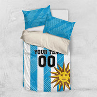 Blue bedding set with white stripe panel, sun motif, crest, and "YOUR TEXT 00" duvet.