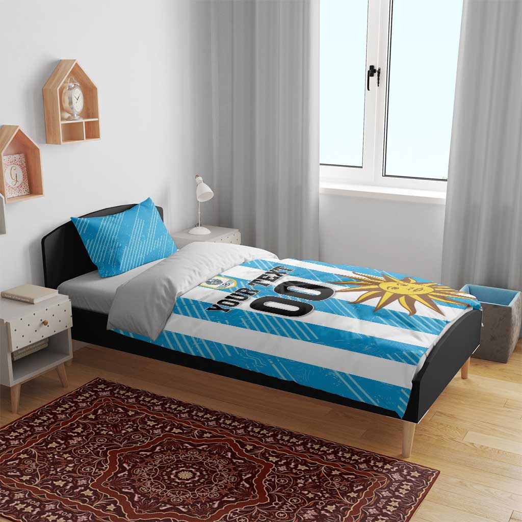 Blue football bedding set with white stripes, sun graphic, crest, and "YOUR TEXT 00".