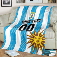 Blue and white striped football blanket on armchair with sun graphic and 'YOUR TEXT 00' text.