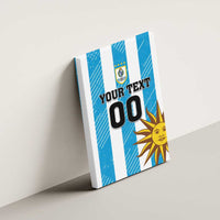 Blue striped canvas wall art featuring Uruguay crest, sun icon, and YOUR TEXT 00