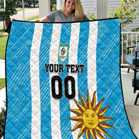 Blue football quilt spread out with white diagonal stripes, sun art, crest, and 00