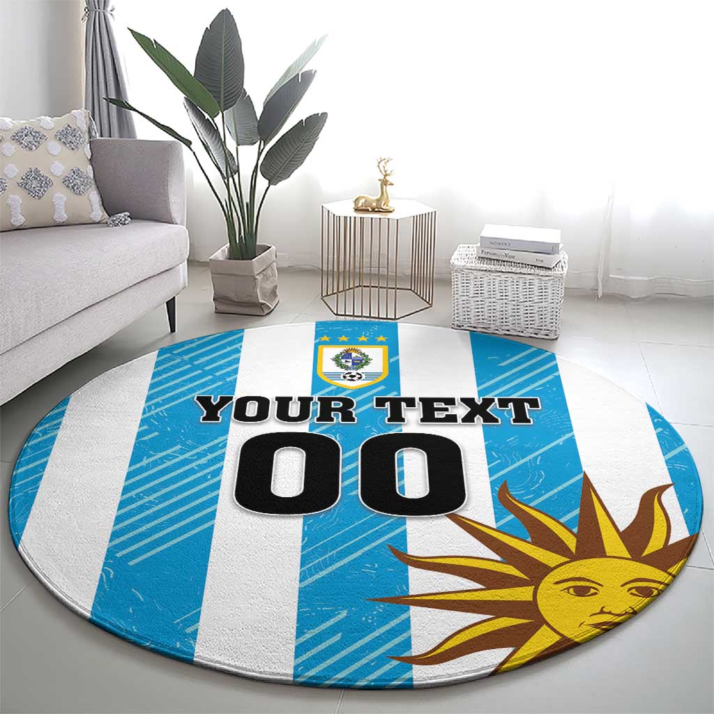Round Uruguay-themed carpet with blue-and-white stripes, sun face, and crest under text