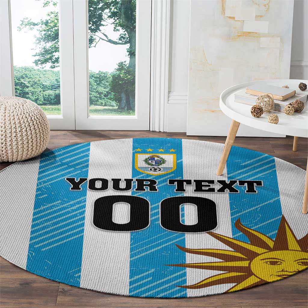 Round Uruguay carpet with blue-and-white stripes, sun face, and crest above custom text