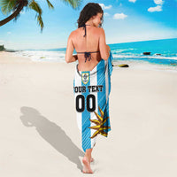 Blue and white striped sarong featuring crest, “YOUR TEXT 00”, and sun graphic