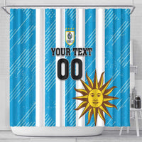 Blue shower curtain with vertical stripes, crest logo, and sun artwork; Your Text 00