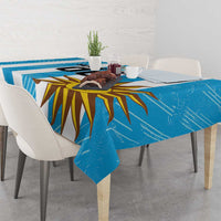 Blue Uruguay football tablecloth on a dining table with sunburst artwork, folded corners
