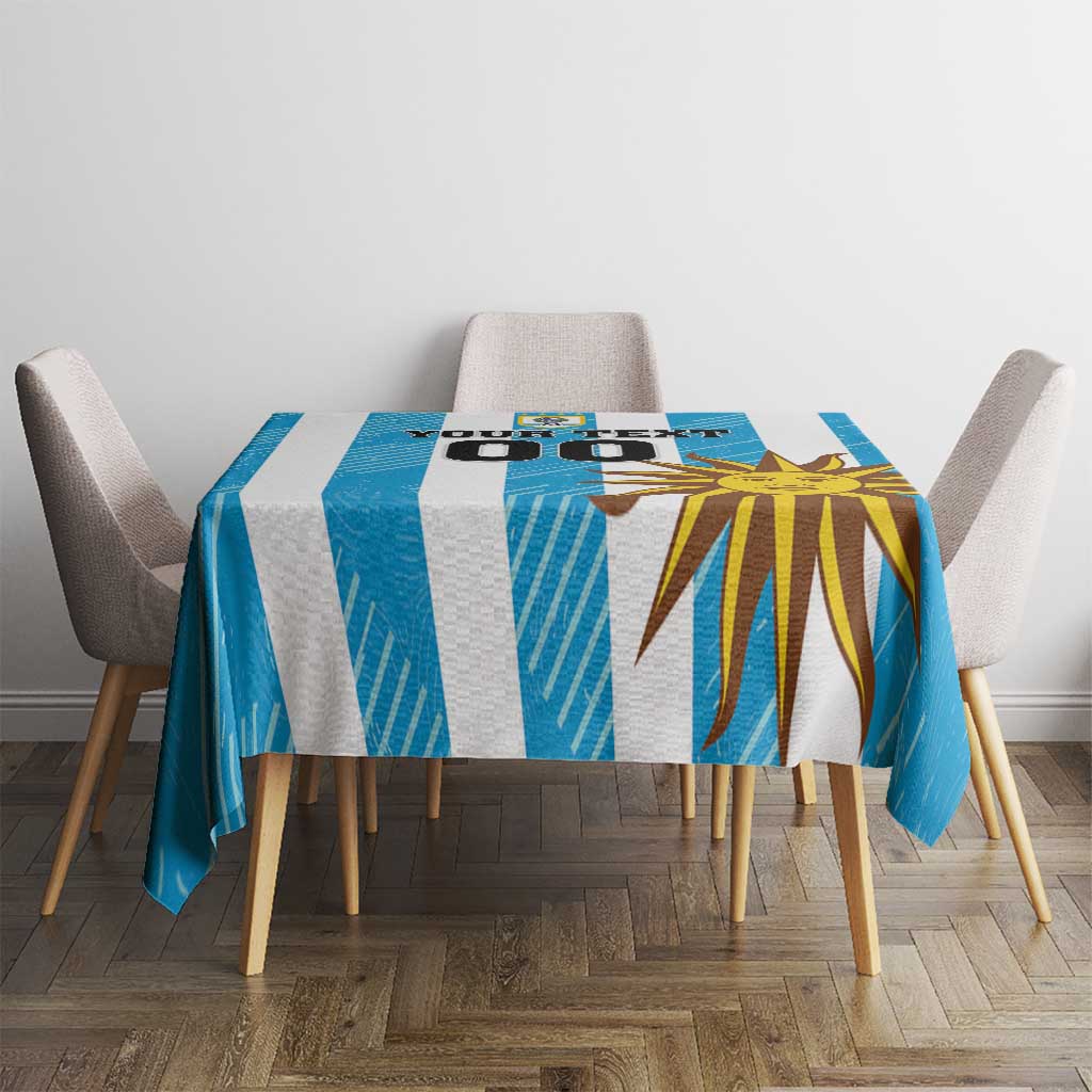 Blue custom tablecloth with sunburst and football graphics on a square table, top view